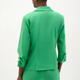 Person wearing a green suit on a white background