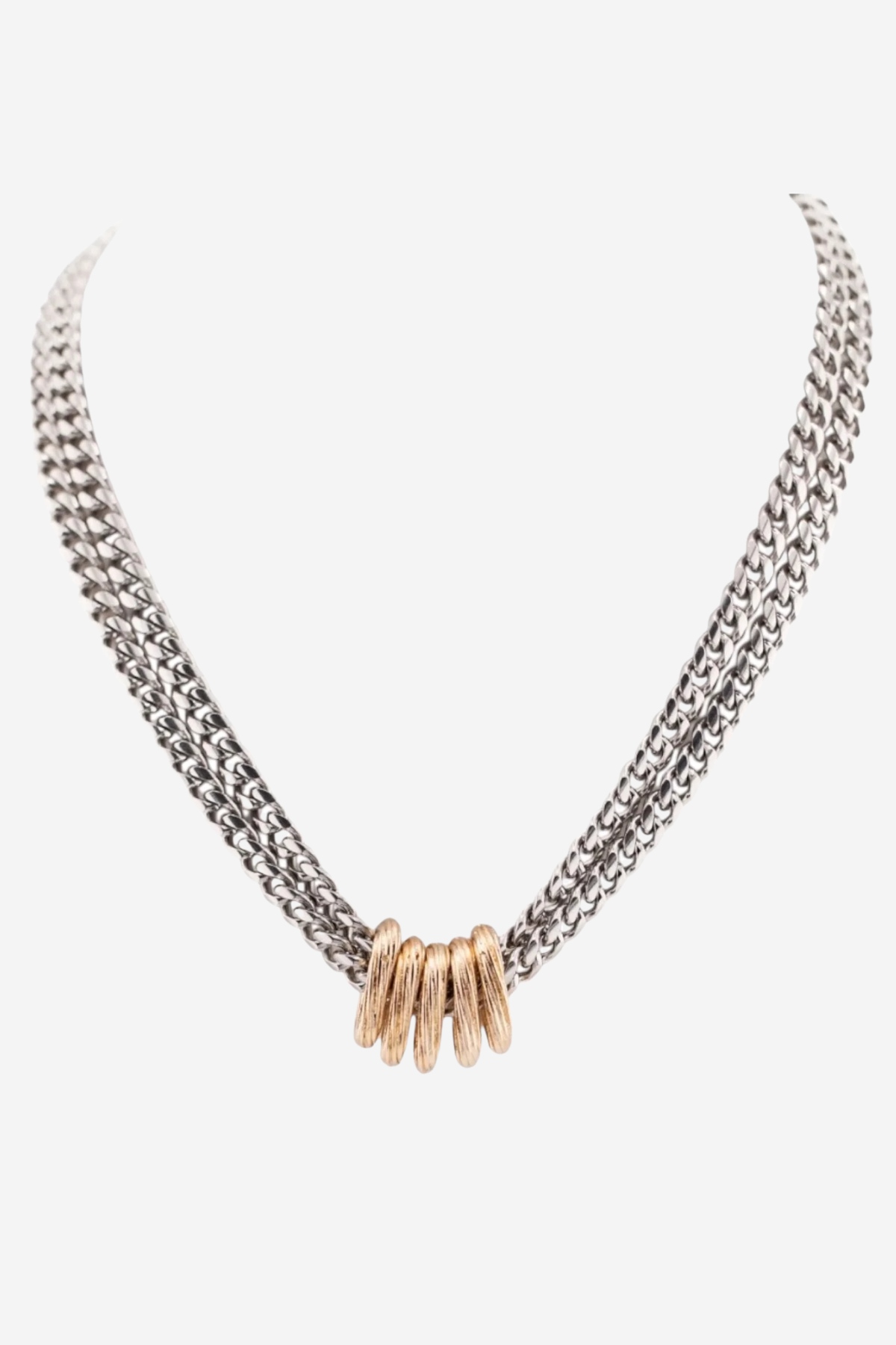 A silver-toned multi-strand chain necklace with a central cluster of textured gold-toned rings, displayed on a light gray background.
