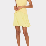 Woman wearing a yellow dress on a white background