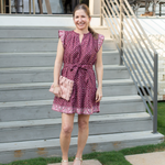 Woman in a patterned dress standing on outdoor steps