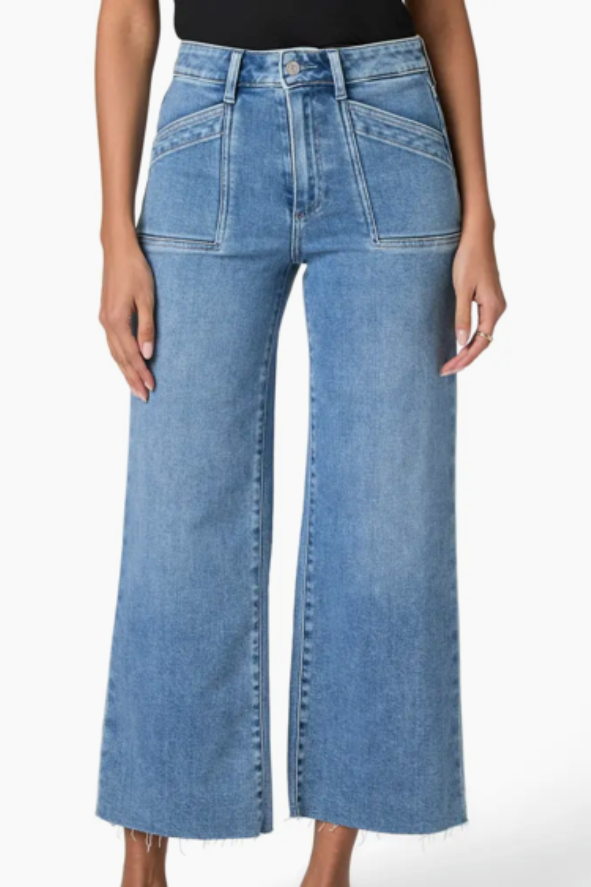 Blue jeans worn by a person on a white background