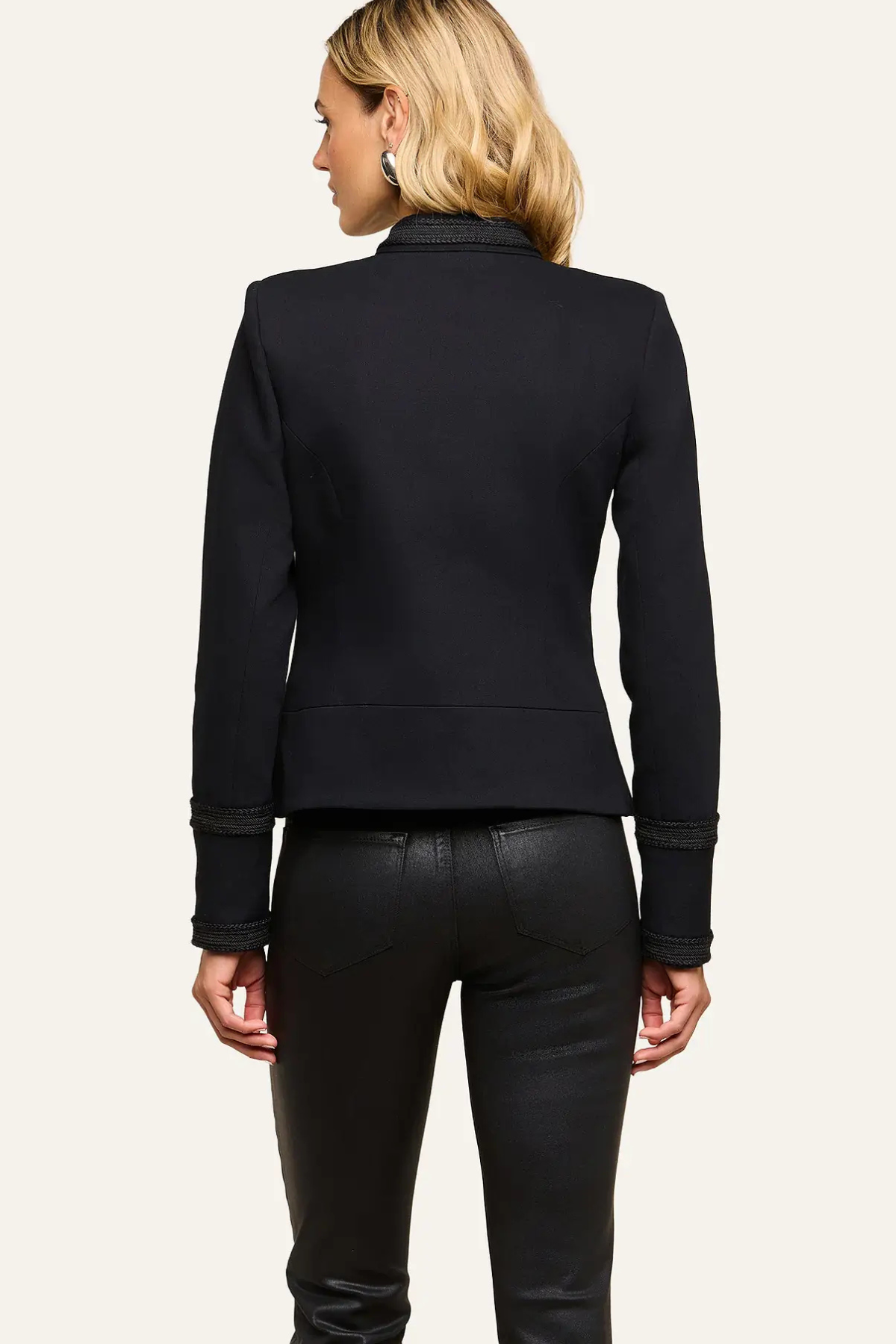 Women's black military-inspired jacket featuring long sleeves and a structured tailored silhouette.