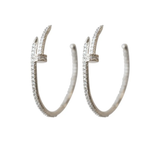 Pair of silver hoop earrings with small stones on a white background
