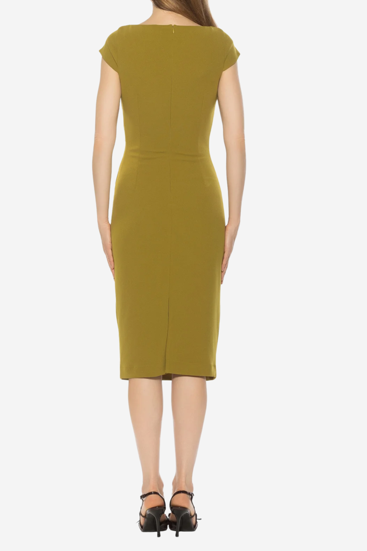 A woman viewed from the back wearing a knee-length olive yellow dress with cap sleeves and black high-heeled sandals, against a plain light gray studio background.
