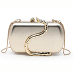 A metallic gold clutch bag with a sculptural snake design wrapping around the front, set against a plain white background.