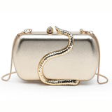 A metallic gold clutch bag with a sculptural snake design wrapping around the front, set against a plain white background.