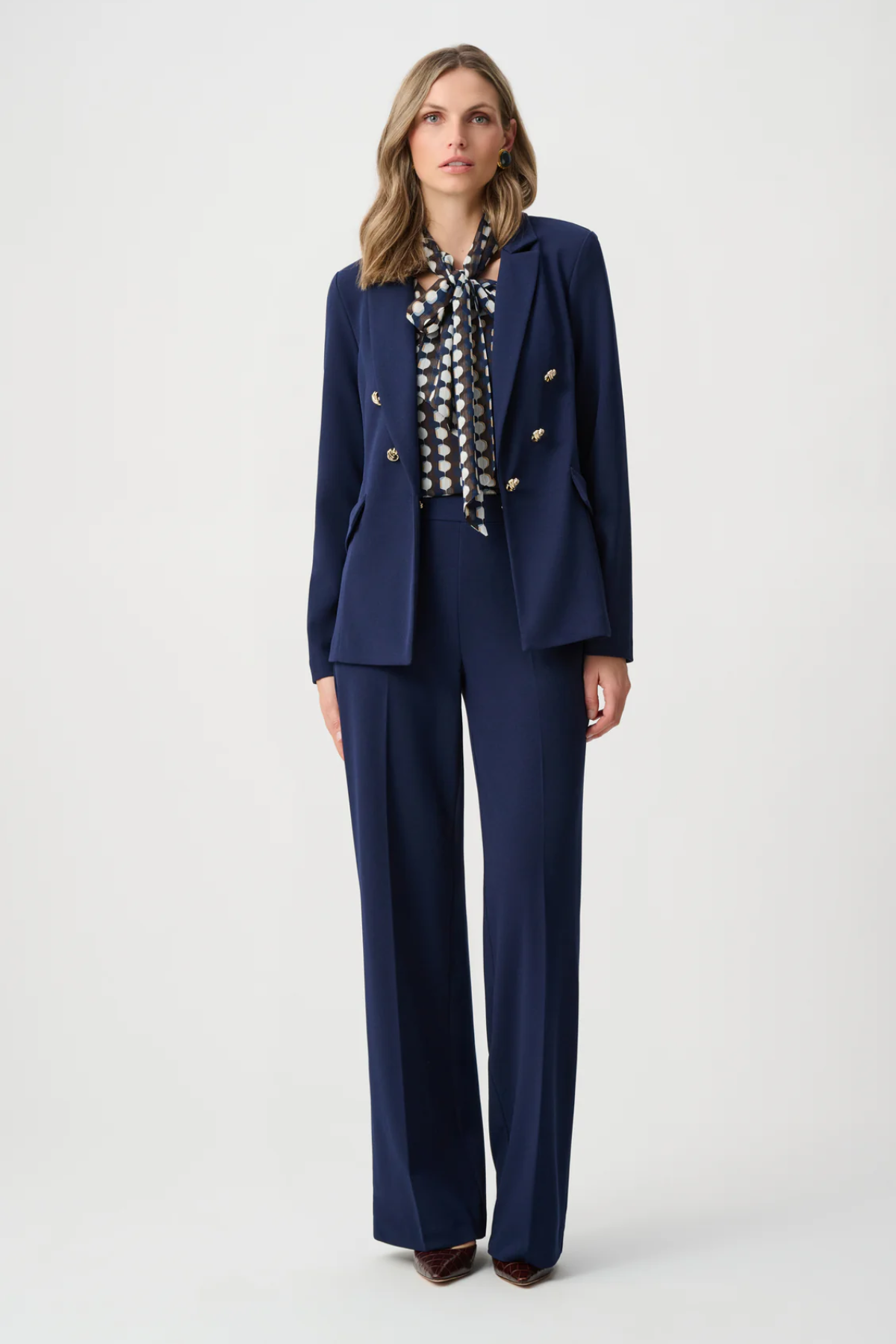 Model wearing navy scuba crepe pull-on wide-leg pants.