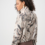 Woman wearing a patterned jacket on a white background