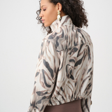 Woman wearing a patterned jacket on a white background