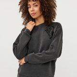 Women's gray modal sweater featuring long sleeves and decorative embellishment detailing.