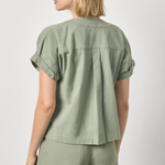 Woman wearing a green outfit on a white background