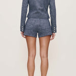 Person wearing a blue set with shorts on a white background