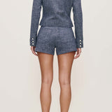 Person wearing a blue set with shorts on a white background