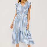 Woman wearing a blue and white striped dress on a white background