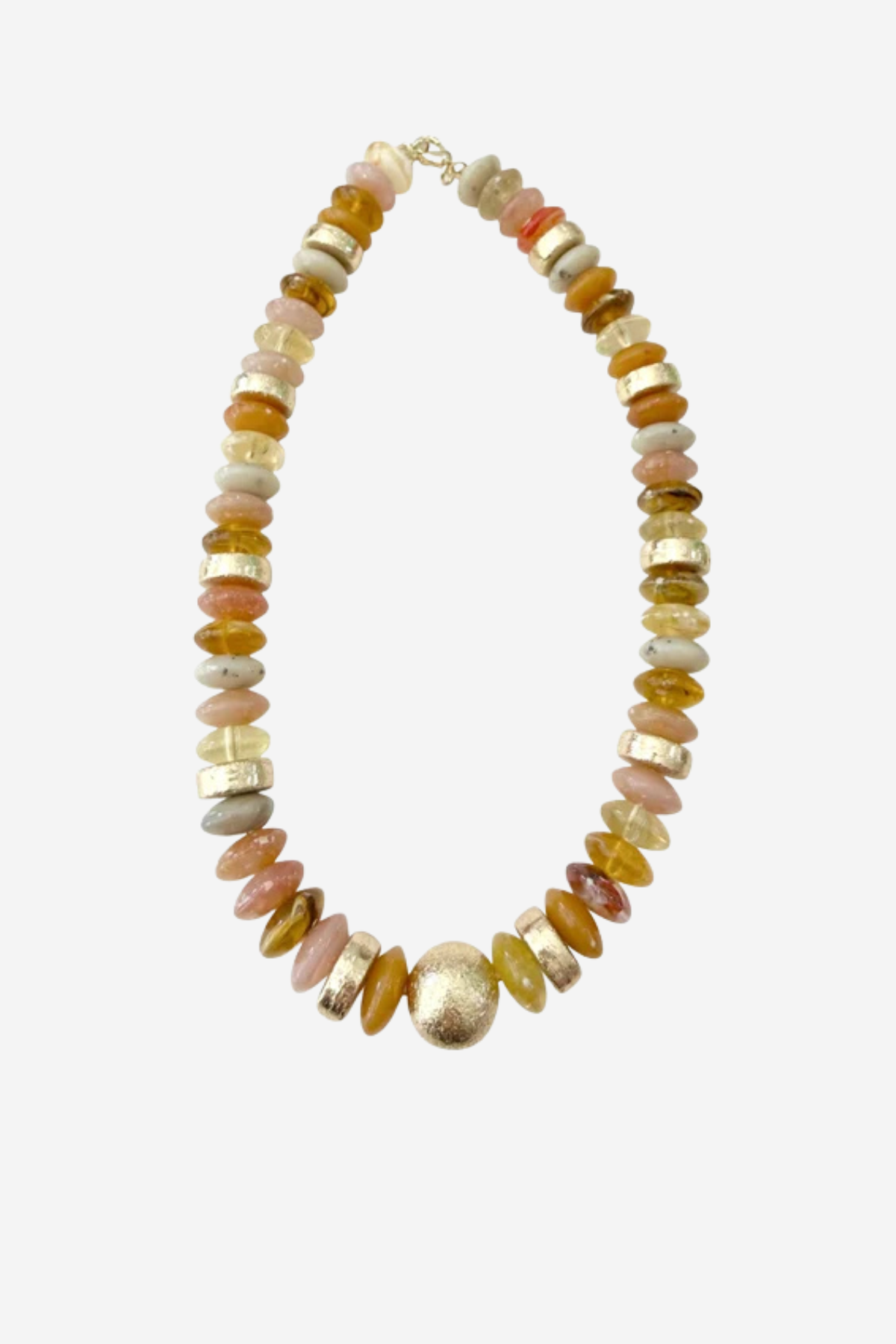 A beaded necklace featuring a mix of polished gold, amber, pink, and cream-colored stones, with a prominent textured gold bead at the center, displayed on a light gray background.