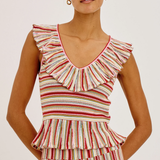 Woman wearing a striped sleeveless top with ruffled details on a white background