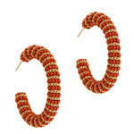 Pair of hoop earrings with gemstone embellishments on a white background