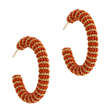 Pair of hoop earrings with gemstone embellishments on a white background