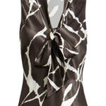 A sleeveless satin blouse with a brown and white abstract pattern, featuring a wrap-style collar with a large front bow, shown on a plain white background.