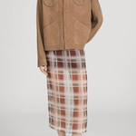 Person wearing a brown jacket and plaid skirt on a white background