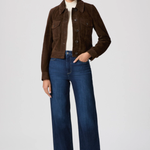 Woman wearing a brown jacket and blue jeans on a white background