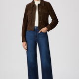 Woman wearing a brown jacket and blue jeans on a white background