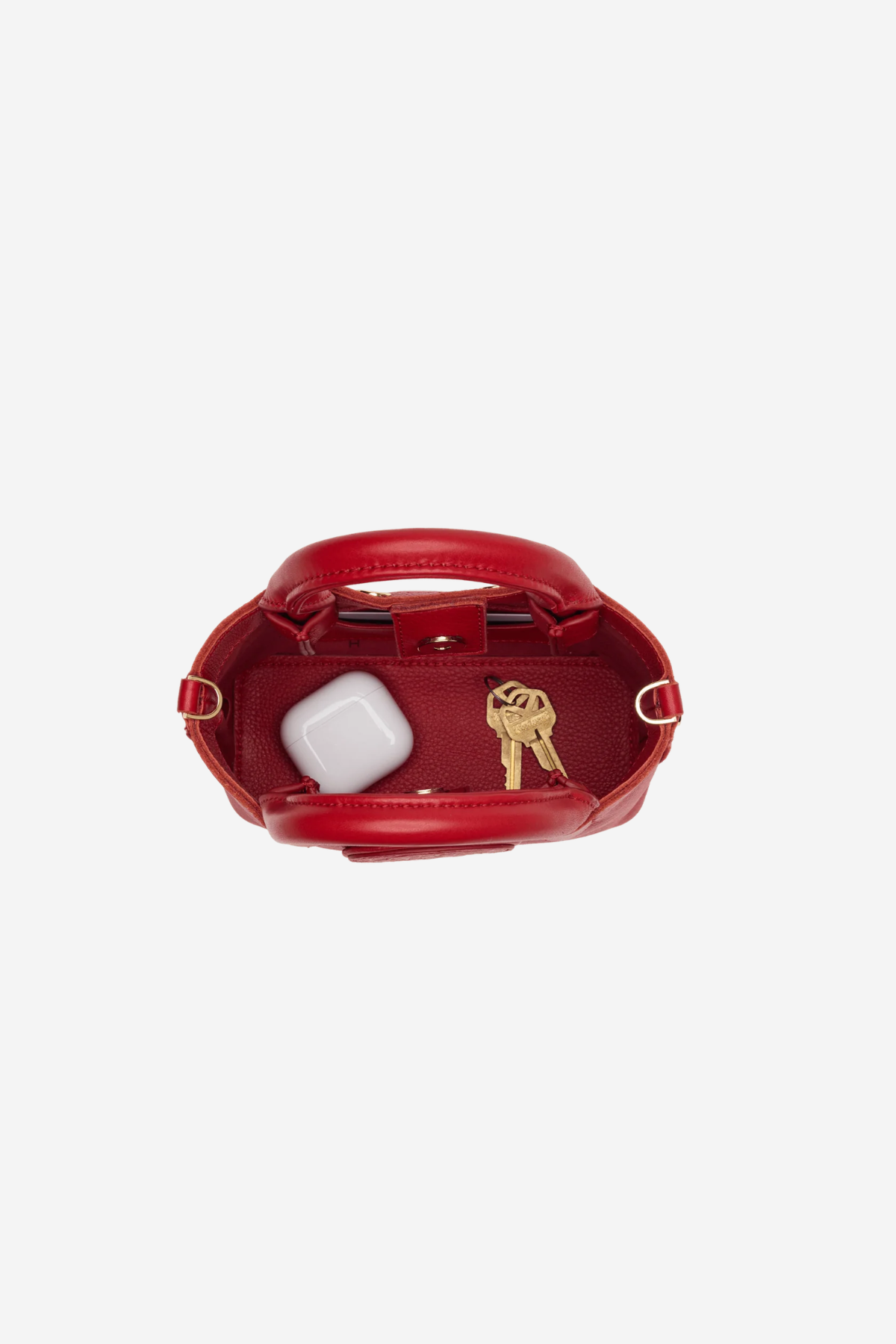 Small structured red tote bag with dual top handles and a compact, polished silhouette.