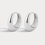 A pair of polished silver huggie hoop earrings with a smooth, rounded teardrop-like profile, displayed on a clean light gray background.
