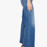 Blue jeans worn by a person on a white background