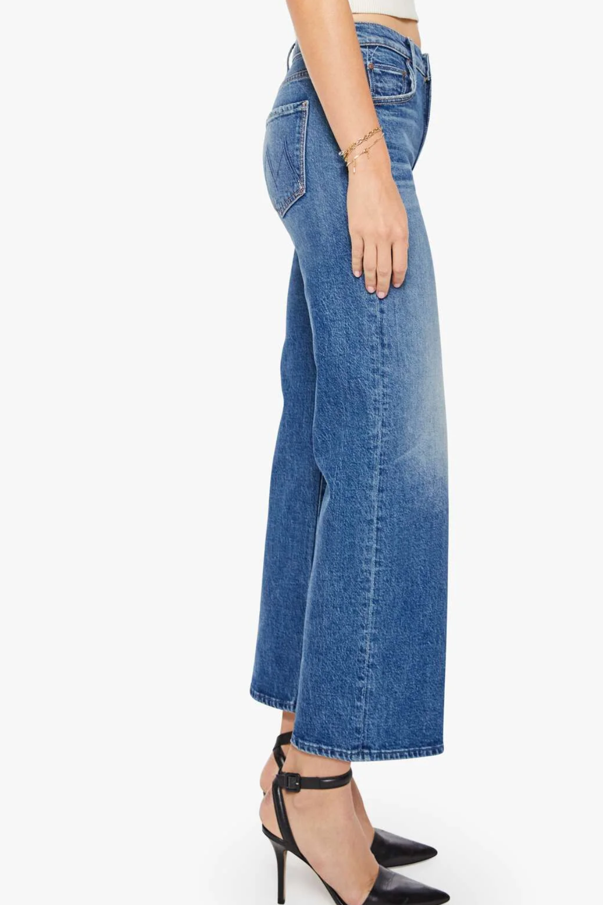 Blue jeans worn by a person on a white background