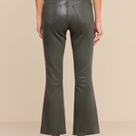 A model shown from the back wearing olive green faux-leather flare pants, a black belt, a black top, and black high heels against a solid beige background.
