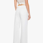 back of woman in white outfit on white background 