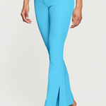 Light blue flared pants worn by a person on a white background