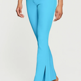 Light blue flared pants worn by a person on a white background