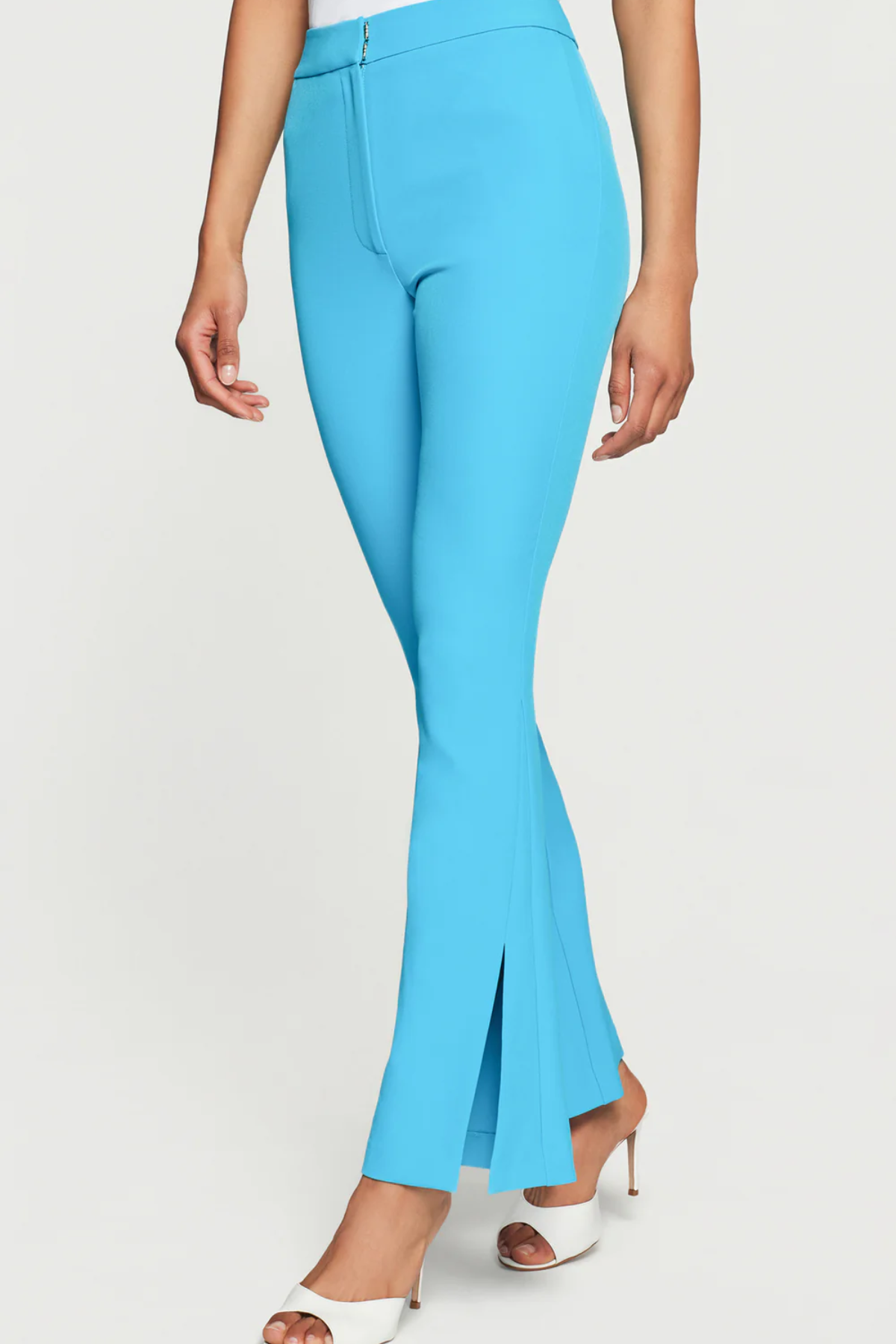 Light blue flared pants worn by a person on a white background