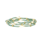 Green beaded bracelet with gold accents on a white background