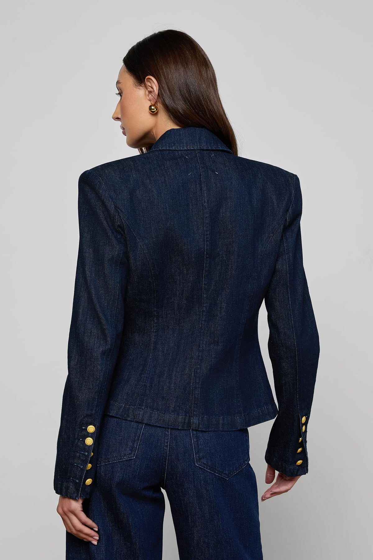 Navy structured blazer styled over a simple top.