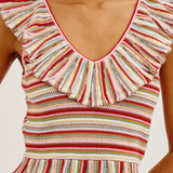 Woman wearing a striped sleeveless top with ruffled details on a white background