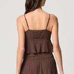 Model wearing a mahogany and ecru color-block camisole with adjustable straps.