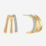 Gold crescent hoop earrings with pavé-set clear crystals and small accent stones, shown on a light gray background.