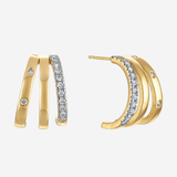 Gold crescent hoop earrings with pavé-set clear crystals and small accent stones, shown on a light gray background.