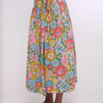 Person wearing a colorful floral skirt on a white background