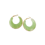 Green hoop earrings with gold accents on a white background