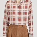 Person wearing a plaid shirt and brown shorts on a white background