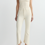 woman in cream outfit on white background 