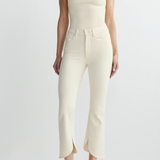 woman in cream outfit on white background 
