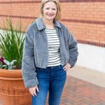 Faux fur zip-up jacket with a plush collar in a neutral tone
