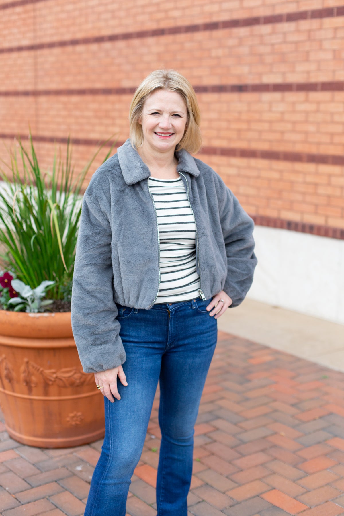 Faux fur zip-up jacket with a plush collar in a neutral tone