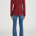 Person wearing a red jacket and blue jeans on a white background