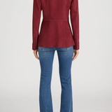 Person wearing a red jacket and blue jeans on a white background